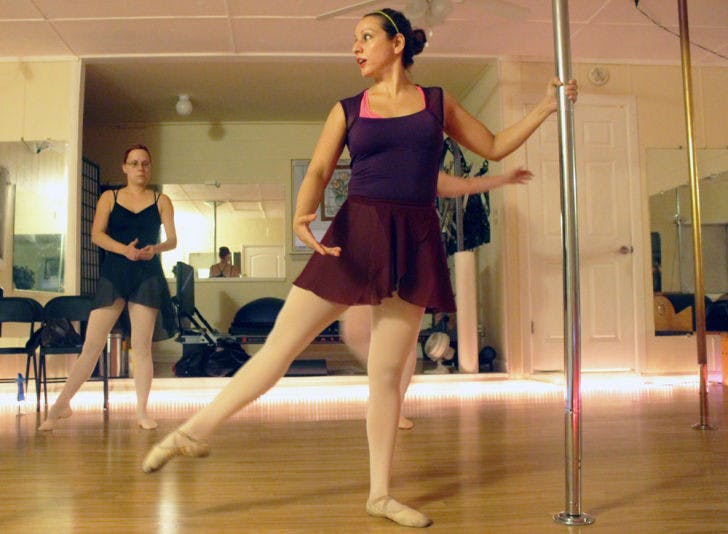 Jacqueline Valdez, 41, teaches a vertical ballet class Monday at Elegant Body Pilates studio at 4003 NW 18th Place. Vertical ballet uses a vertical pole and focuses on conditioning, flexibility and posture.