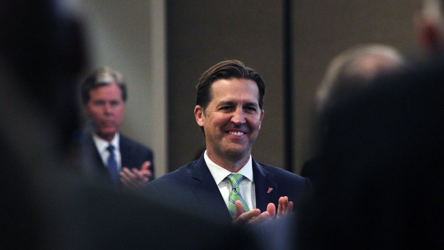 Republican U.S. Sen Ben Sasse, of Nebraska, applauds President Kent Fuchs at the Board of Trustees meeting to discuss his candidacy at Emerson Alumni Hall Tuesday, Nov. 1, 2022.