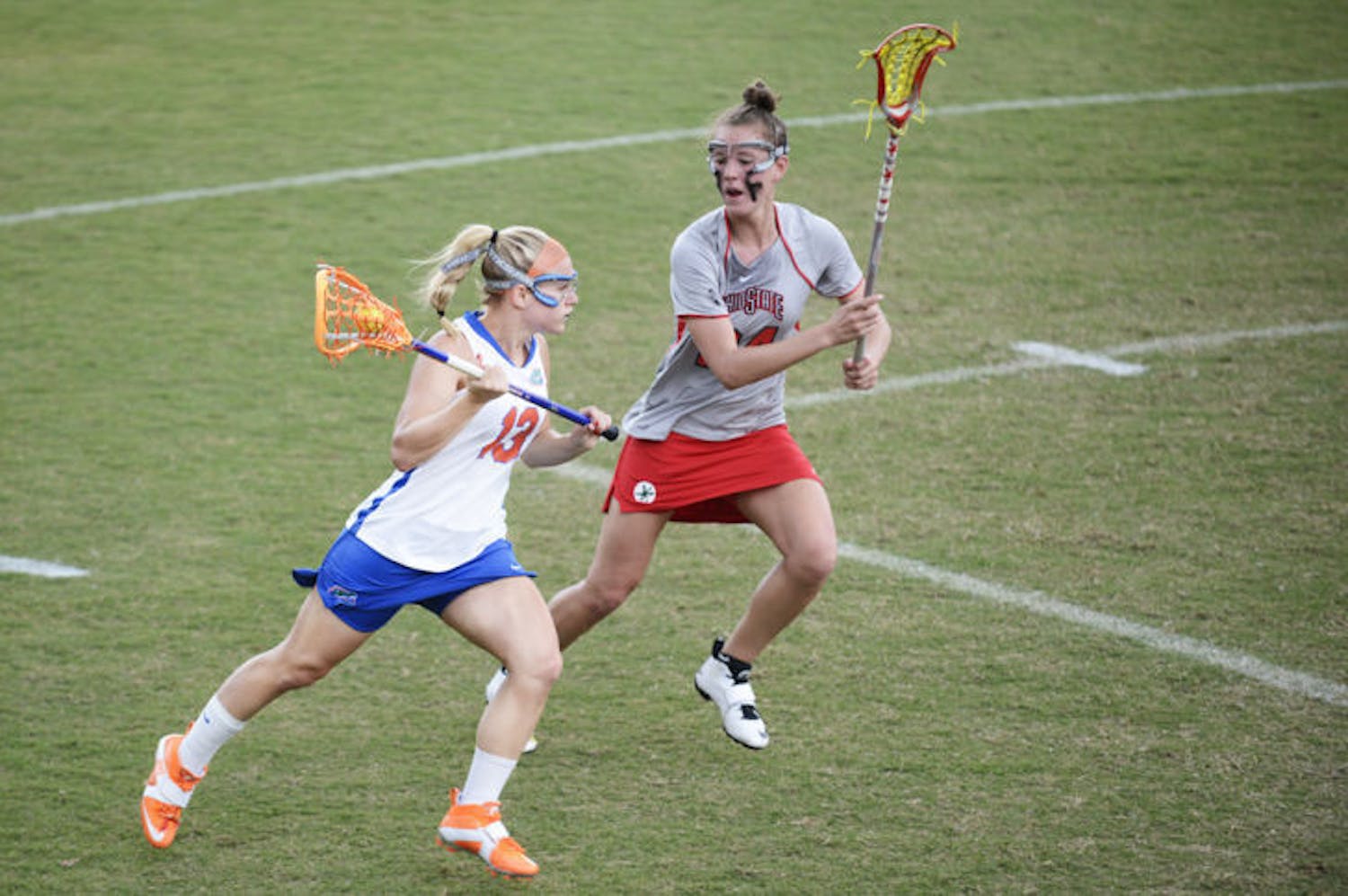 Florida’s Ashley Bruns (13) attacks the net against Ohio State defender Tayler Kuzma (24) in the Gators’ 13-7 win against the Buckeyes on March 23 at Dizney Stadium. Northwestern held Bruns to one goal in Florida's 8-3 loss on Sunday.