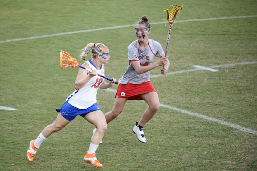 <p class="p1"><span class="s1">Florida’s Ashley Bruns (13) attacks the net against Ohio State defender Tayler Kuzma (24) in the Gators’ 13-7 win against the Buckeyes on March 23 at Dizney Stadium. Northwestern held Bruns to one goal in Florida's 8-3 loss on Sunday.</span></p>