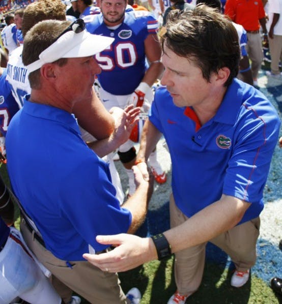 Coach Will Muschamp and Kentucky offensive coordinator Randy Sanders shake hands after Florida’s 38-0 win on Sept. 22 at Ben Hill Griffin Stadium. The Swamp will host an array of football recruits when No. 10 Florida takes on No. 4 LSU.