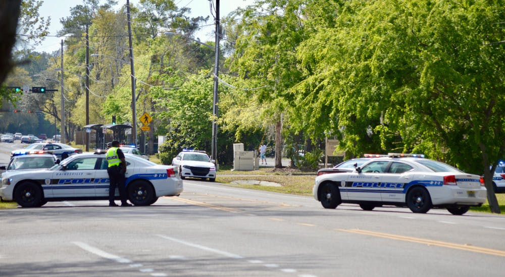 Police vehicles surround the Windsor Terrace apartments on Southwest 20th Avenue following a shooting at the apartment complex Sunday afternoon.