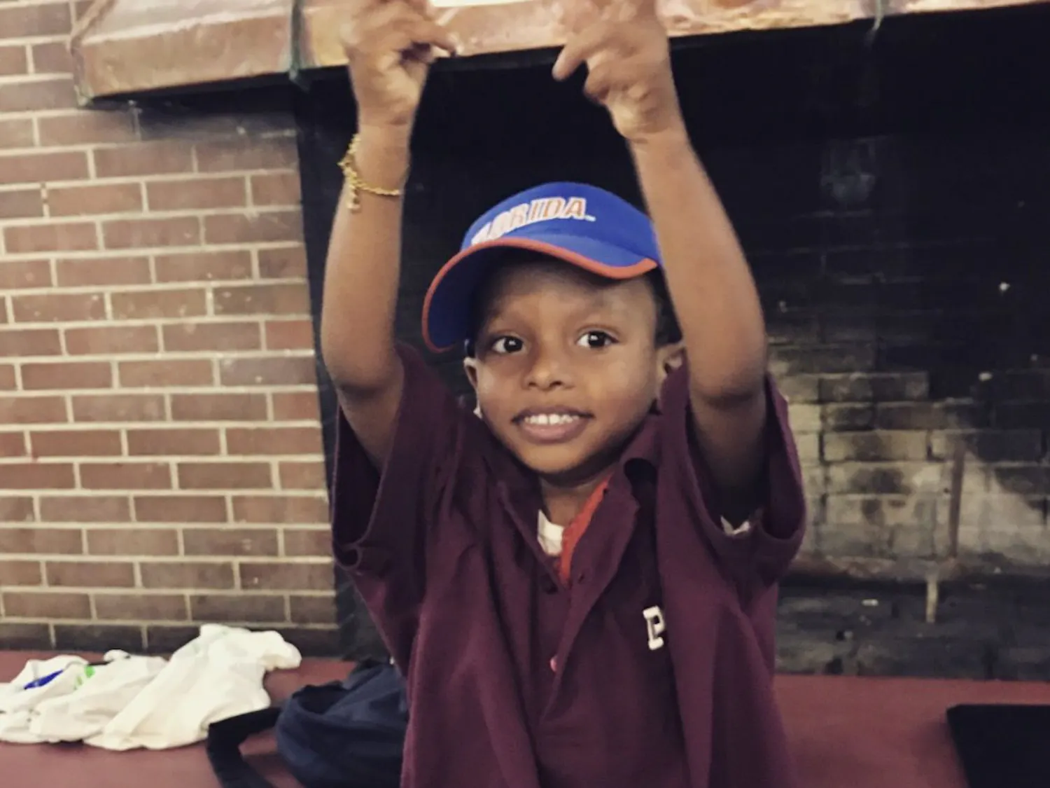 Declan Patrick, a three-year-old UF Health Shands patient, holds up his honorary bid card to UF Pi Kappa Alpha. The fraternity gave Declan a basketball and football signed by all the fraternity brothers.
