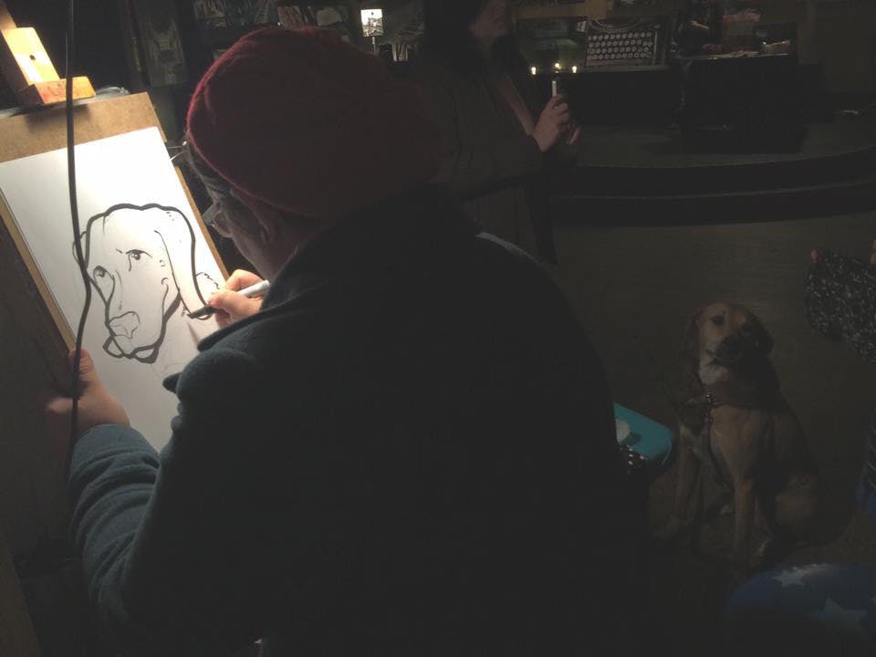 Local caricature artist Corinne Halley draws a caricature of a patron’s dog during February’s Art Attack at High Dive, 210 SW Second Ave. High Dive’s Art Attack will be part of Artwalk Gainesville for the first time on Friday. While the event is free, donations are welcomed to keep the event free of charge for its patrons and vendors.