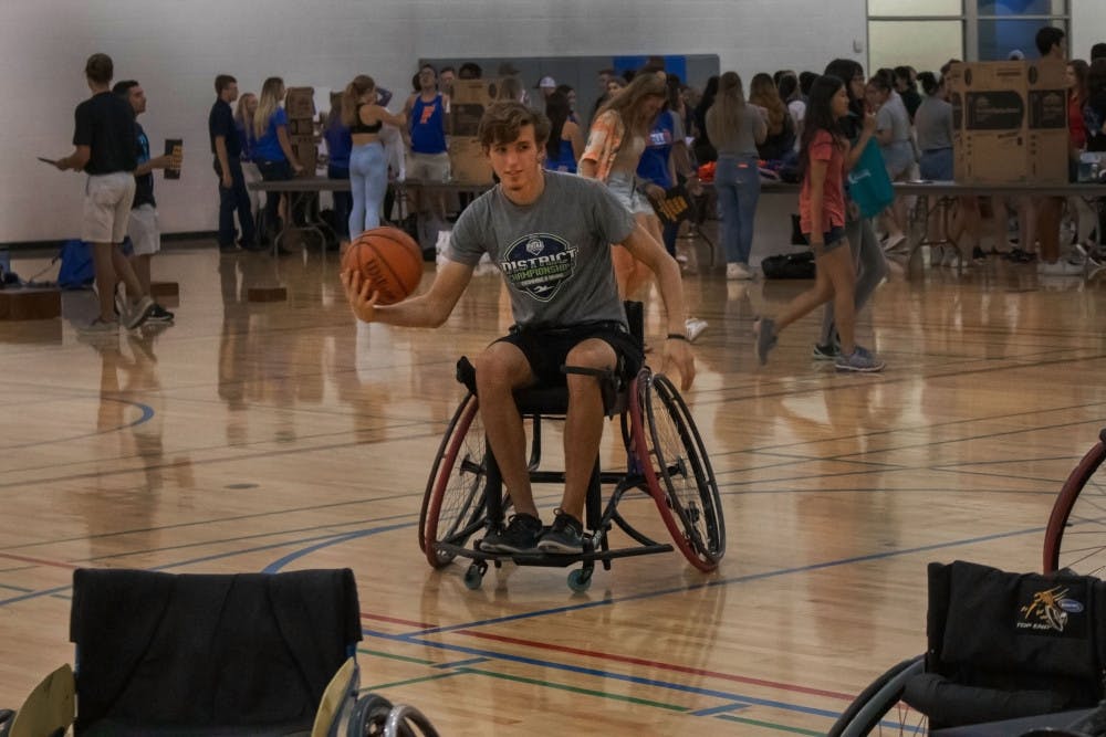 TJ Comer, an 18-year-old wildlife ecology freshman, plays wheelchair basketball Thursday evening as part of the Inclusivity project at RecSports. Every other semester, wheelchair basketball is offered as a sport for UF students to compete in. Students who aren’t handicapped are encouraged to join to raise awareness for disabilities and to understand people who have disabilities. “It’s a lot harder than I thought it would be,” Comer said. “But eventually I got used to it.” He said he was planning on joining intramural basketball and flag football but is now considering joining wheelchair basketball.  