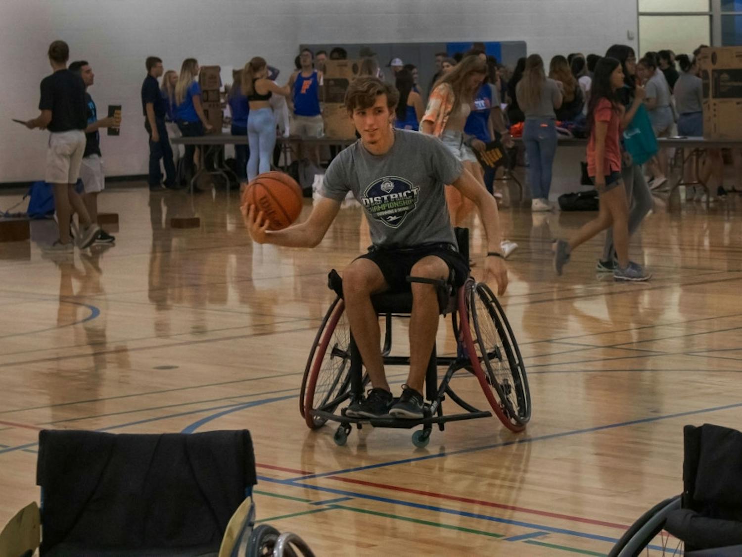 TJ Comer, an 18-year-old wildlife ecology freshman, plays wheelchair basketball Thursday evening as part of the Inclusivity project at RecSports. Every other semester, wheelchair basketball is offered as a sport for UF students to compete in. Students who aren’t handicapped are encouraged to join to raise awareness for disabilities and to understand people who have disabilities. “It’s a lot harder than I thought it would be,” Comer said. “But eventually I got used to it.” He said he was planning on joining intramural basketball and flag football but is now considering joining wheelchair basketball.