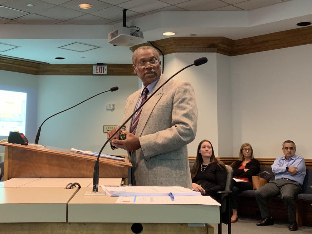 Lawrence Calderon, a Gainesville city planner, uses a laser pointer to address a projection screen while presenting a PowerPoint to the Gainesville Development Review Board Tuesday.