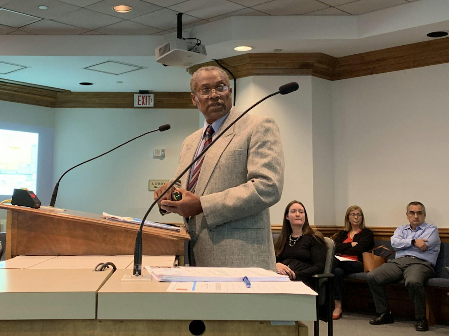 Lawrence Calderon, a Gainesville city planner, uses a laser pointer to address a projection screen while presenting a PowerPoint to the Gainesville Development Review Board Tuesday.