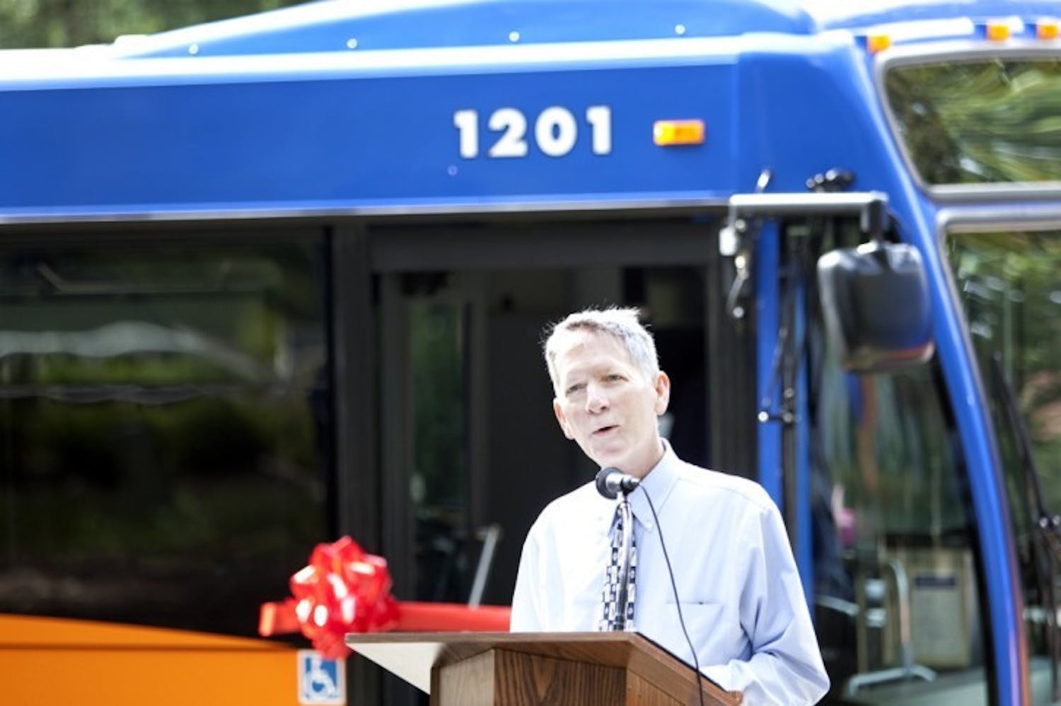 Mayor Craig Lowe speaks at the unveiling of two new biodiesel hybrid Regional Transit System buses Wednesday morning on the Plaza of the Americas. The new buses will run on route 46.