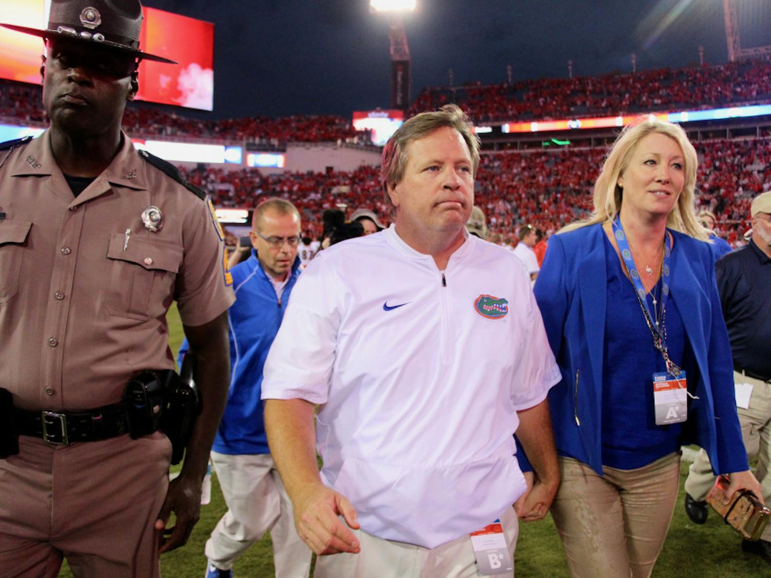 Jim McElwain walks off the field after Florida's 42-7 loss to Georgia on Saturday at EverBank Field in Jacksonville. On Sunday, it was confirmed that McElwain and the UAA mutually agreed to part ways.