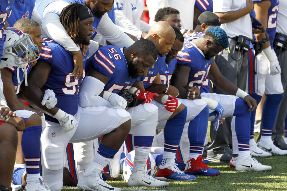 Buffalo Bills players kneel during the national anthem prior to an NFL football game against the Denver Broncos, Sunday, Sept. 24, 2017, in Orchard Park, N.Y. (AP Photo/Jeffrey T. Barnes)
