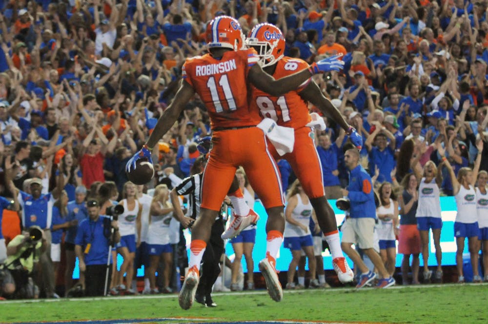 UF wide receivers Demarcus Robinson (11) and Antonio Callaway (81) celebrate after Robinson's first-quarter touchdown during Florida's 38-10 win against Ole Miss on Oct. 3, 2015, at Ben Hill Griffin Stadium.