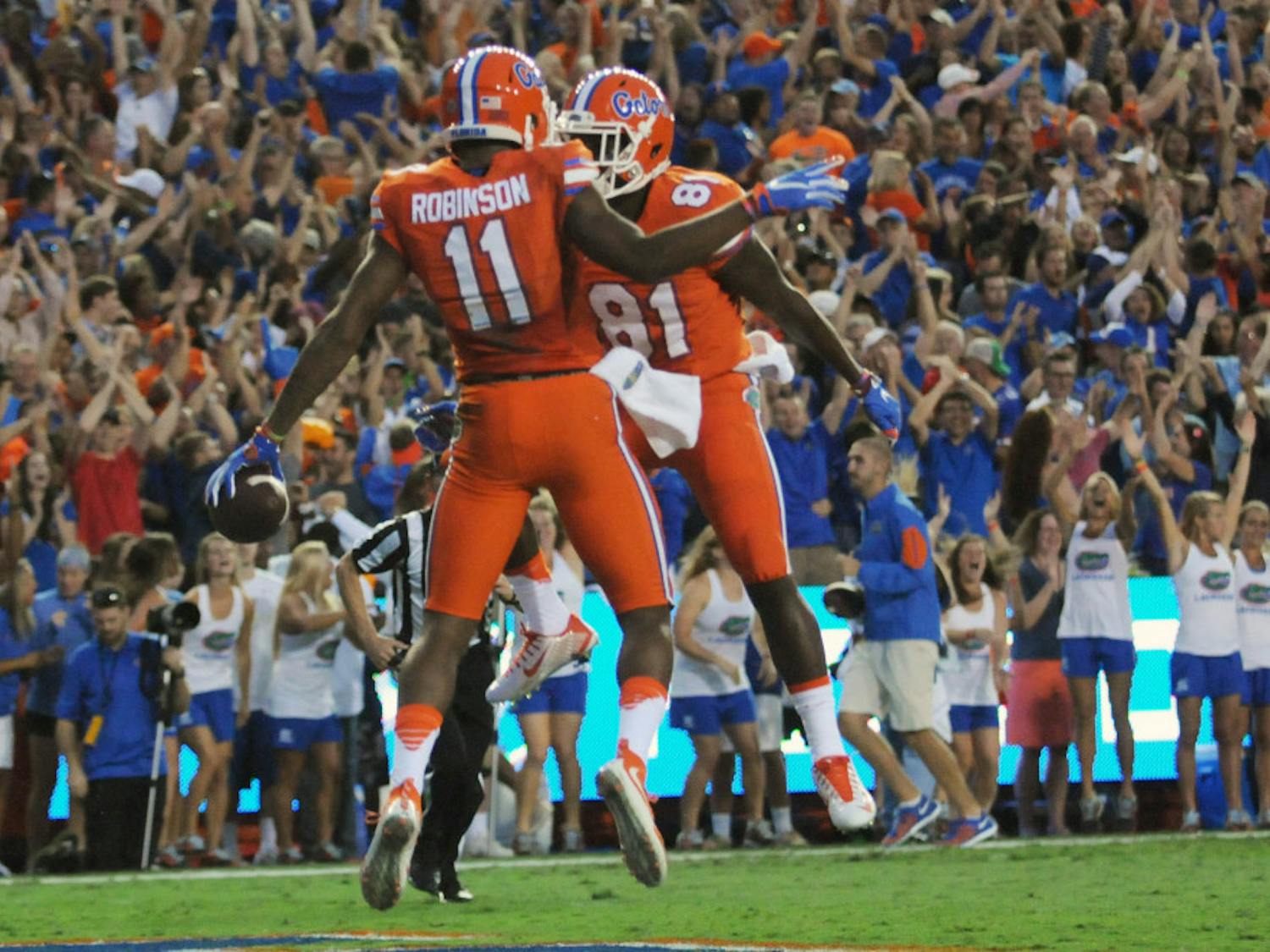 UF wide receivers Demarcus Robinson (11) and Antonio Callaway (81) celebrate after Robinson's first-quarter touchdown during Florida's 38-10 win against Ole Miss on Oct. 3, 2015, at Ben Hill Griffin Stadium.