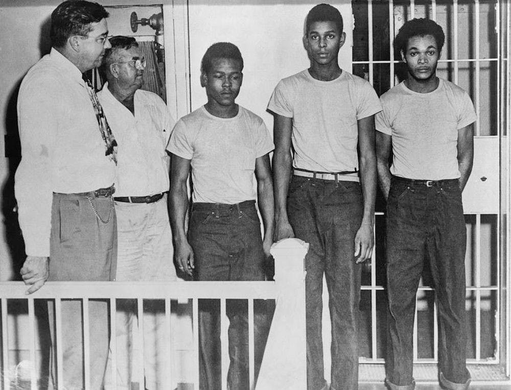 Walter Irvin (third from left), Charles Greenlee, and Samuel Shepherd, stand in a jail after being accused of raping a 17-year-old white girl in Lake County, Florida, in 1949. Since then, Greenlee’s daughter, Carol Greenlee, has petitioned to exonerate her father and the other African American men who were charged alongside him, known as the Groveland Four.