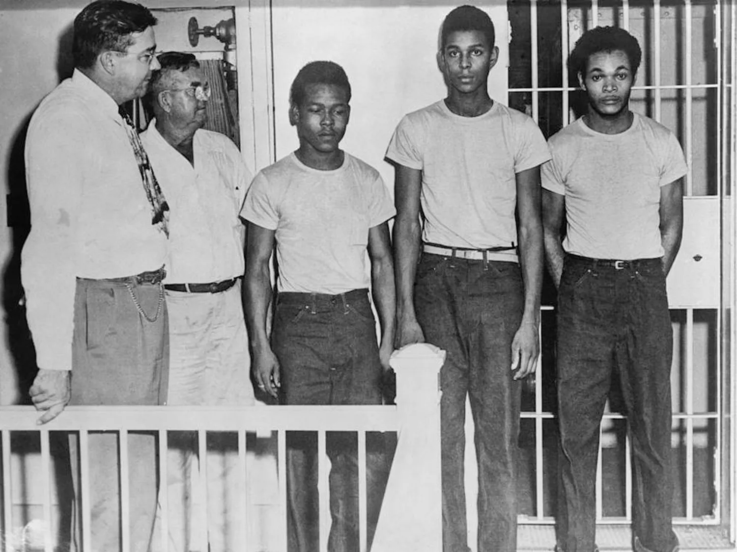 Walter Irvin (third from left), Charles Greenlee, and Samuel Shepherd, stand in a jail after being accused of raping a 17-year-old white girl in Lake County, Florida, in 1949. Since then, Greenlee’s daughter, Carol Greenlee, has petitioned to exonerate her father and the other African American men who were charged alongside him, known as the Groveland Four.