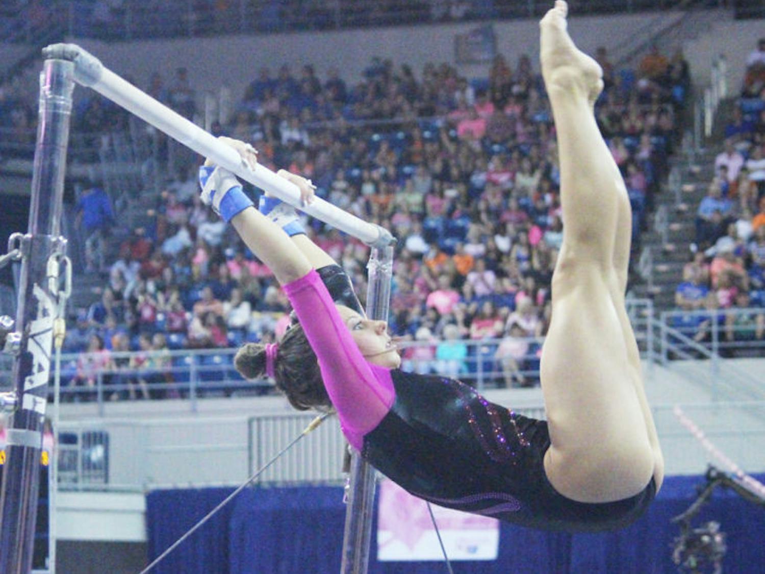 Senior Alaina Johnson performs on the uneven bars during UF’s 198.125-197.625 win against LSU on Feb. 21.