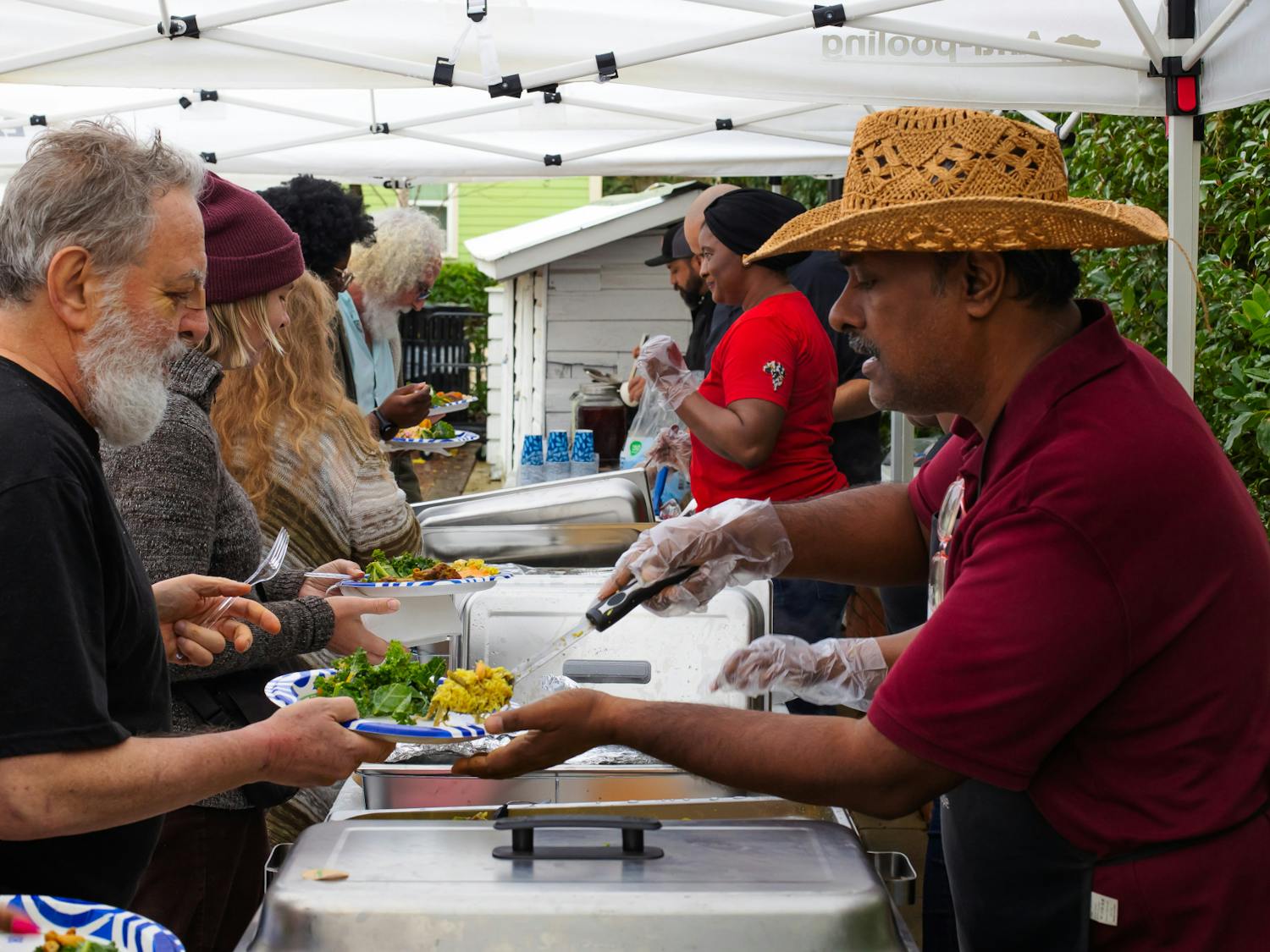 Chef Amnaya Awasthi of Braised Yum serves biryani to event visitors at the A. Quinn Jones Museum on Sunday, Feb. 16, 2025.