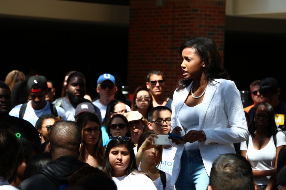 Ebony Love, a 20-year-old UF history junior recites the poem "Still I Rise" by Maya Angelou Friday afternoon in Turlington Plaza. Love helped organize a demonstration to call attention to the police-involved shootings of black men and women.