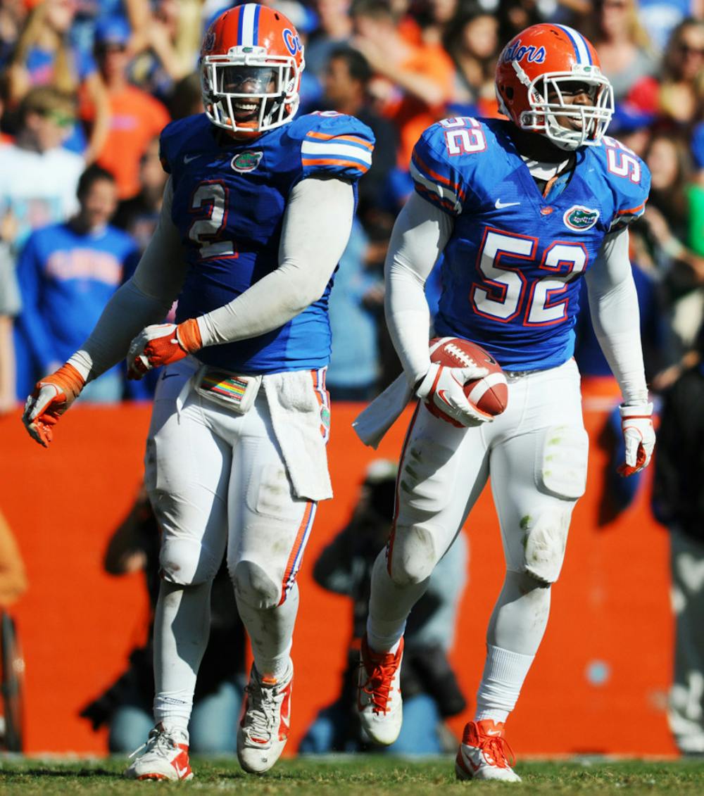 <p>Senior linebacker Jon Bostic (right) said the Gators defense has been playing better and faster thanks to improved communication.</p>