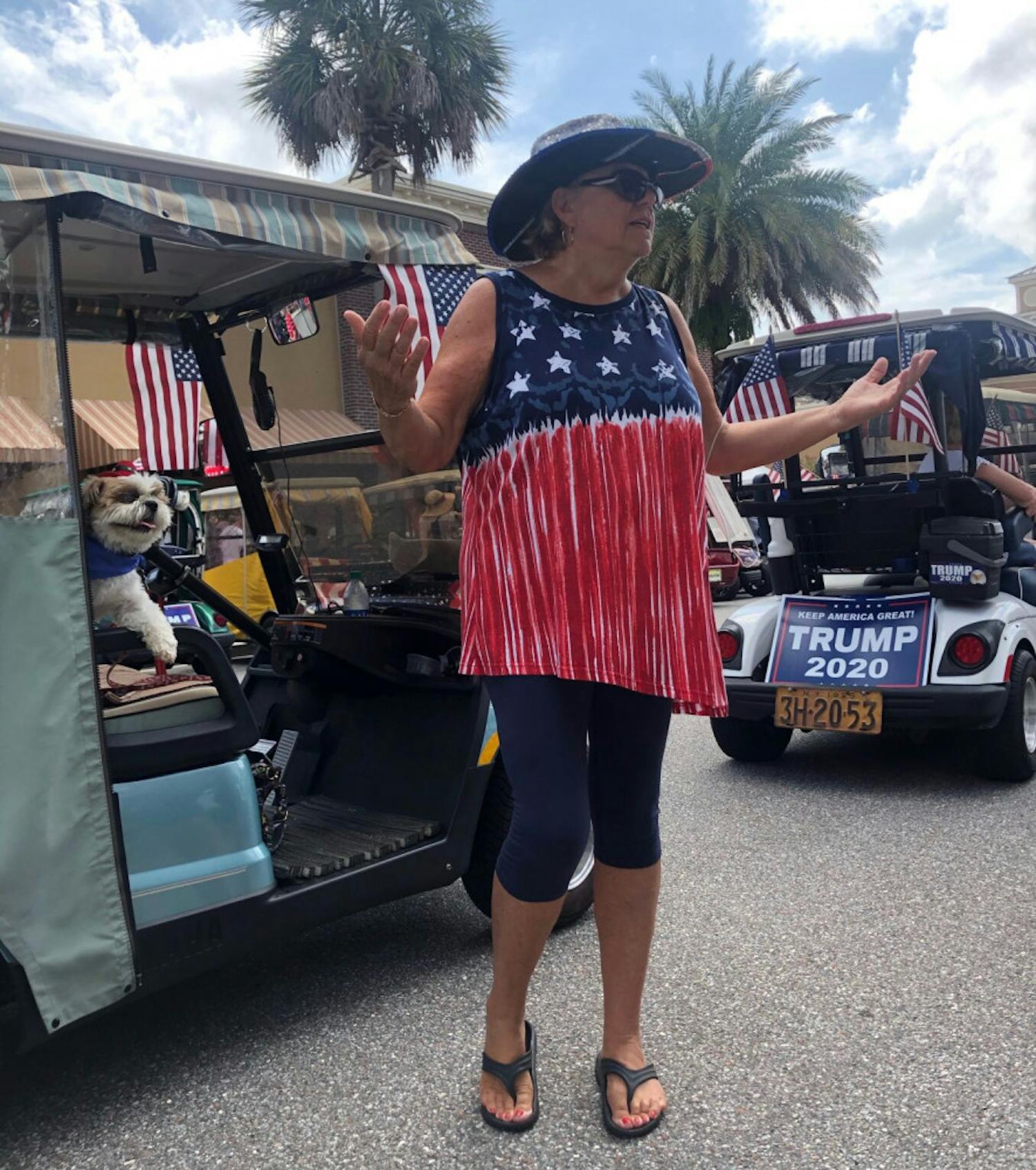 Kathy Slattery, 69, and her dog Samson, 8, waited to enter the event in a line of golf carts waving Trump flags. &nbsp;