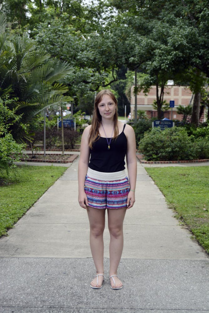 Hannah Westergaard, a 20-year-old UF plant science junior enrolled in the Innovation Academy, poses for a photo on a walkway behind McCarty Hall. Westergaard has dropped the innovation minor and is having difficulties aligning her major’s classes with the Spring-Summer schedule.