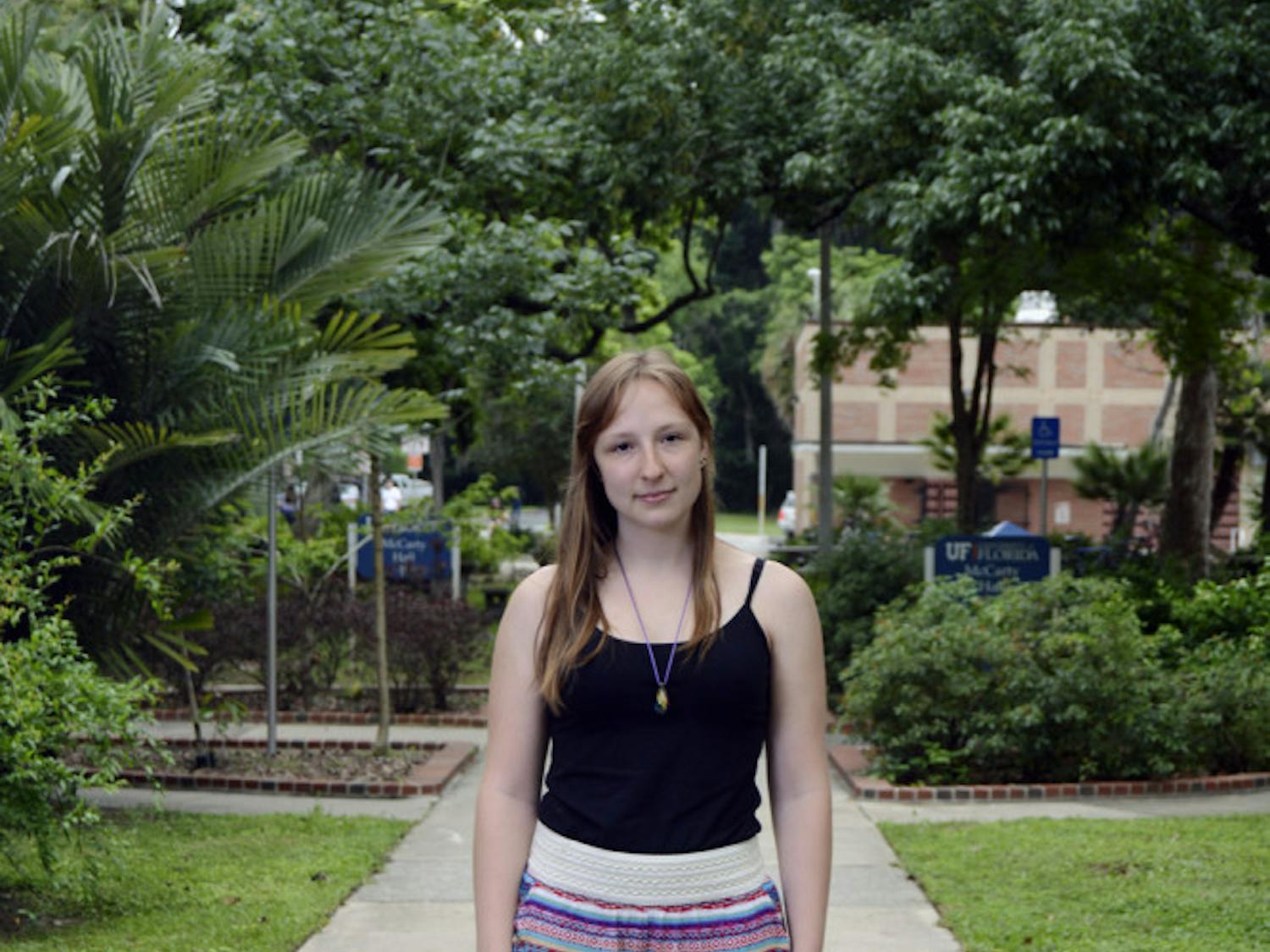 Hannah Westergaard, a 20-year-old UF plant science junior enrolled in the Innovation Academy, poses for a photo on a walkway behind McCarty Hall. Westergaard has dropped the innovation minor and is having difficulties aligning her major’s classes with the Spring-Summer schedule.