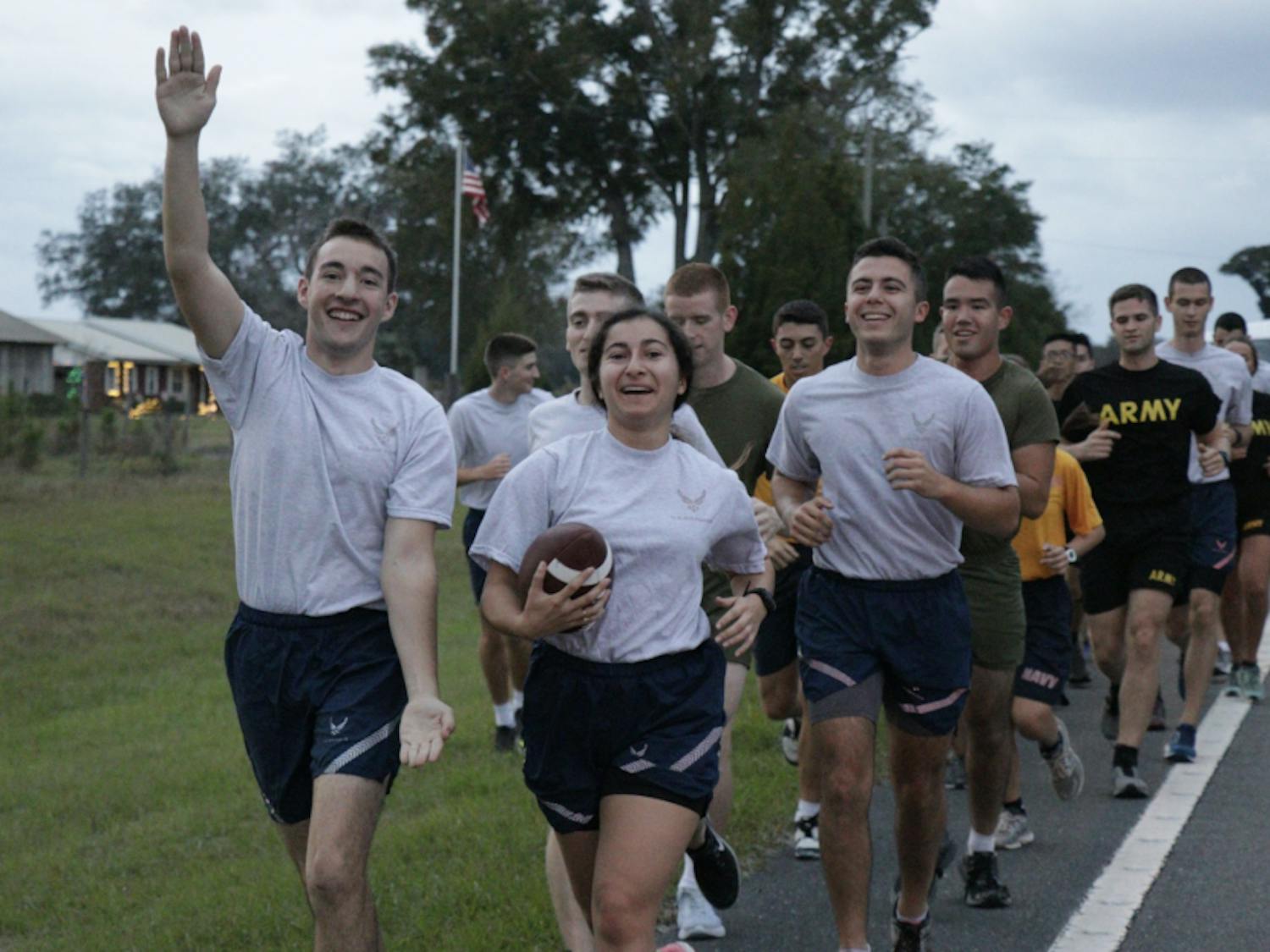 UF Air Force ROTC cadets Jake Gold (left), Destiny Cepero, and Jonathan Toledo hold the game ball during the relay on their way to Gainesville.