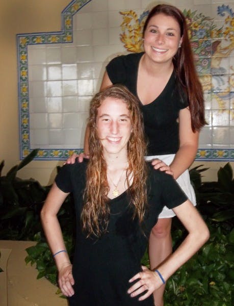 Rebecca Harris, 20, bottom, is squatting below Kayla Fernandez, 21, Harris's big sister in Theta Alpha. Harris died July 11 from injuries after a hit-and-run accident on June 23.