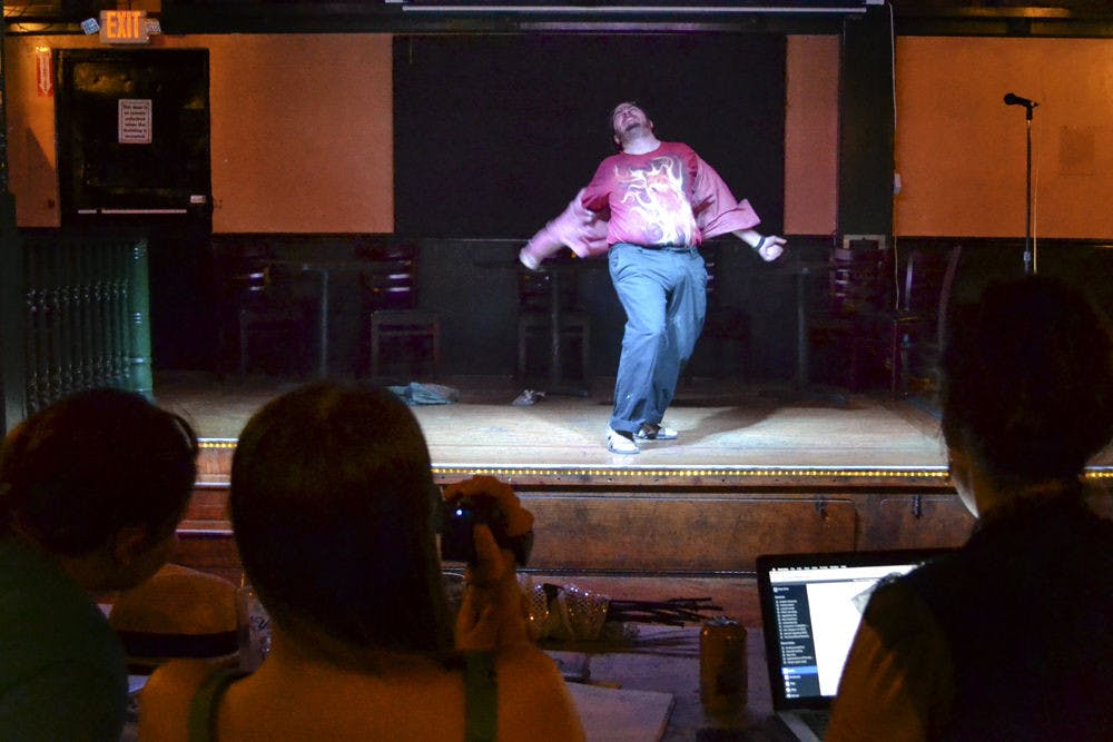 Otto, 29, breaks through his collared shirt with the “Chariots of Fire” theme song in the background of his audition piece for the Breakaway Burlesque troupe on Oct. 27, 2015, at Market Street Pub &amp; Cabaret. Otto came unprepared because his wife and a founder of the troupe, Florence Rosé, told him the night before he would be auditioning.
