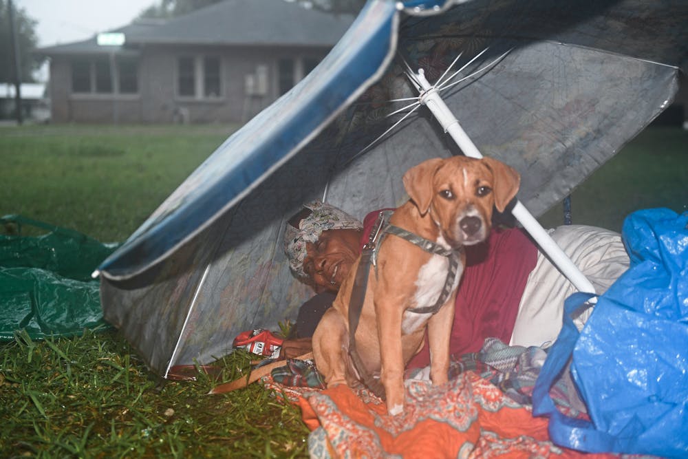 <p>Christell and her dog Cupid shelter from the rain on Sunday, Oct. 6, 2024, in Gainesville, Florida.</p>