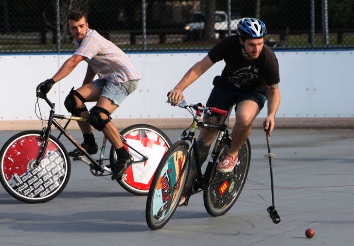 Justin Pogge, 31, races ahead of Travis Mitchell, 26, during open play of the Canadian Tuxedo Invitational Bike Polo Tournament on Saturday.