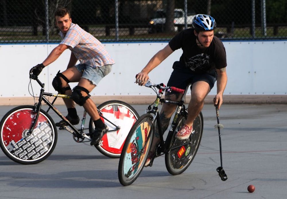 <p>Justin Pogge, 31, races ahead of Travis Mitchell, 26, during open play of the Canadian Tuxedo Invitational Bike Polo Tournament on Saturday.</p>