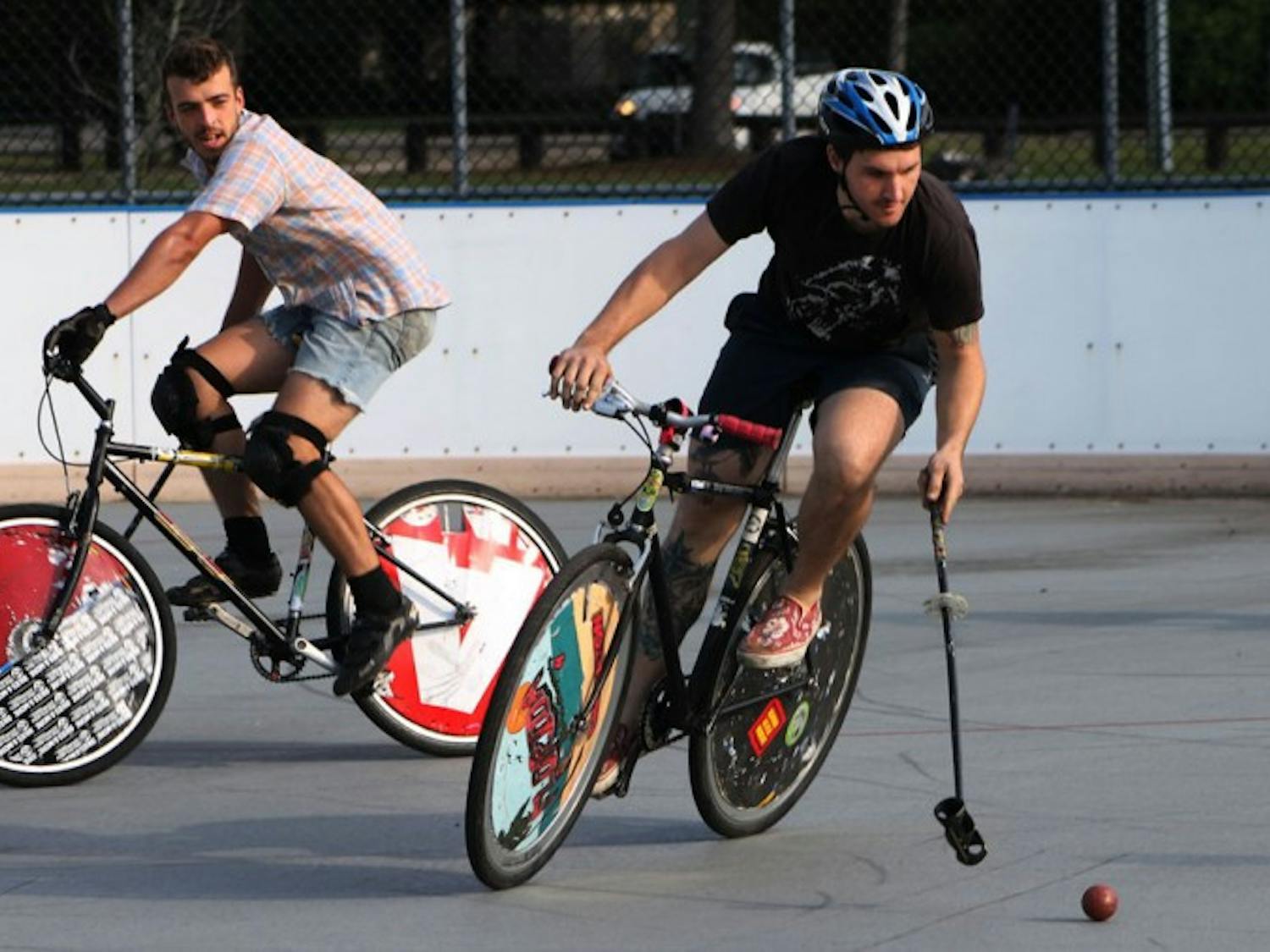 Justin Pogge, 31, races ahead of Travis Mitchell, 26, during open play of the Canadian Tuxedo Invitational Bike Polo Tournament on Saturday.