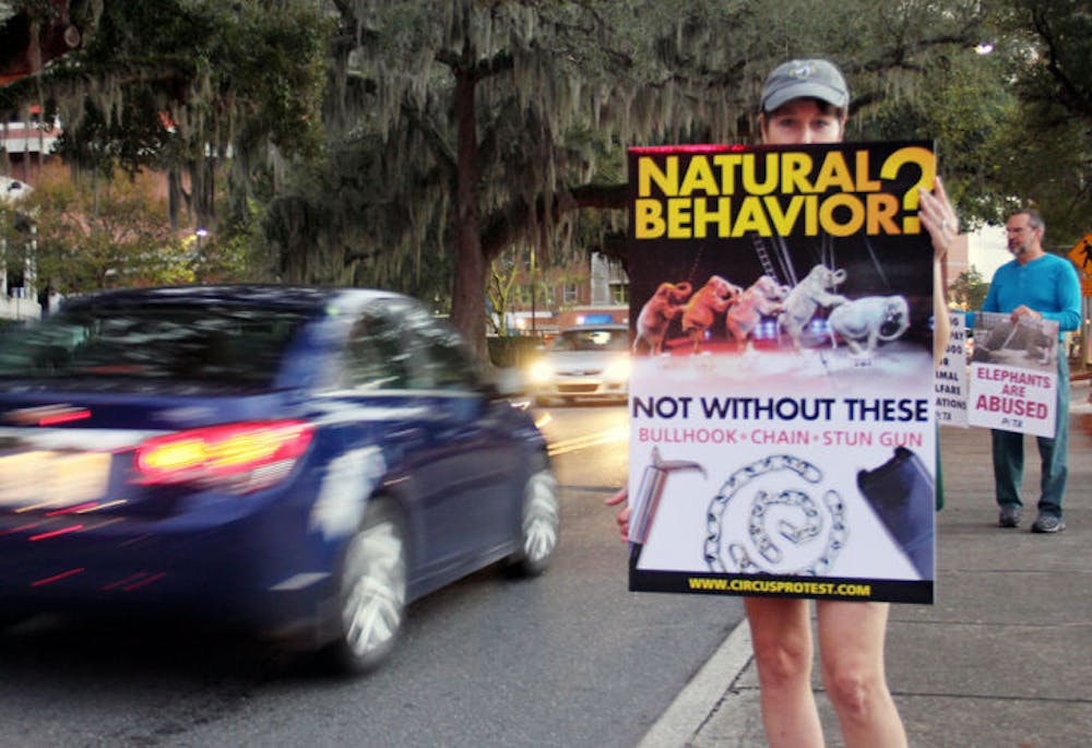 <p class="p1"><span class="s1">A protester stands on the corner of West University Avenue and Gale Lemerand Drive on Friday in objection to weekend The Ringling Bros. Circus appearance in Gainesville. Protesters gathered with signs to voice their opinions on the circus’s treatment of its animals.</span></p>