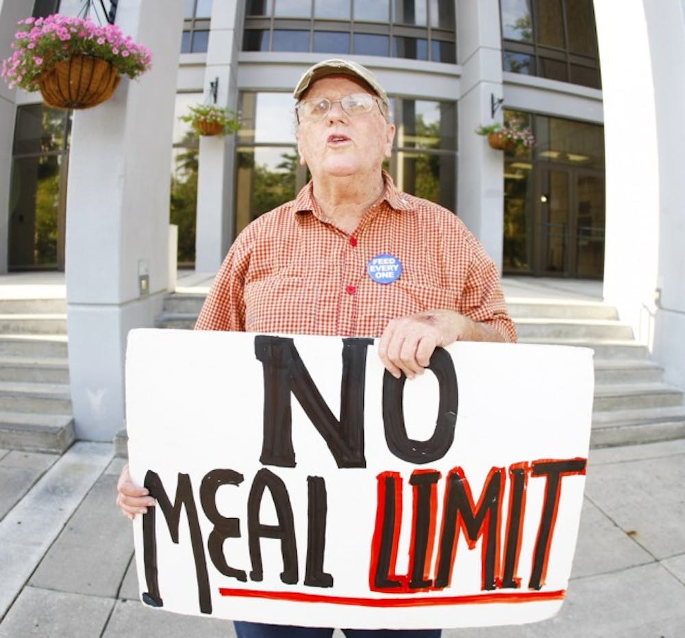 <p>Pat Fitzpatrick stands outside City Hall on Monday afternoon. Fitzpatrick and other protestors were arrested last October for trespassing on Bo Diddley Community Plaza.</p>
