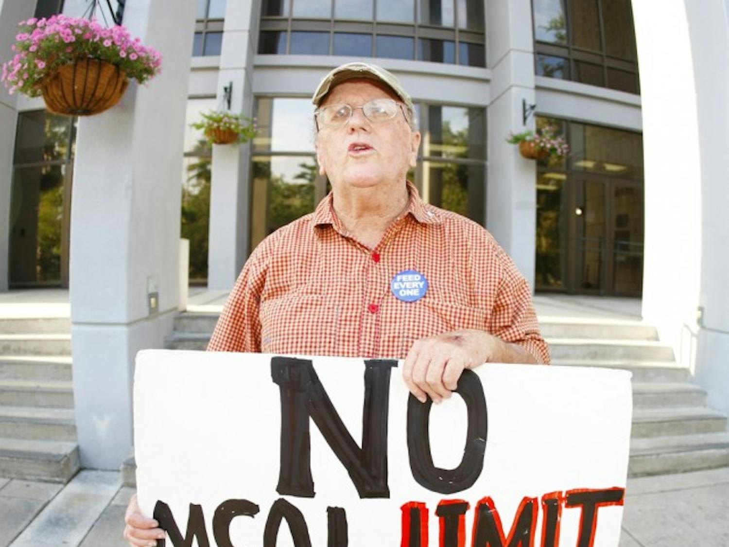 Pat Fitzpatrick stands outside City Hall on Monday afternoon. Fitzpatrick and other protestors were arrested last October for trespassing on Bo Diddley Community Plaza.