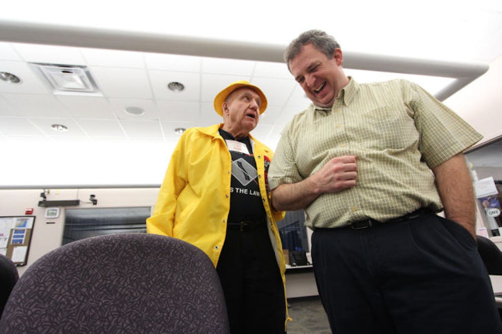 <p>David Donnelly, 44, leads Jack Varnon, 79, a citizen advocate for the blind community, to his chair after a lunch break Thursday afternoon.</p>