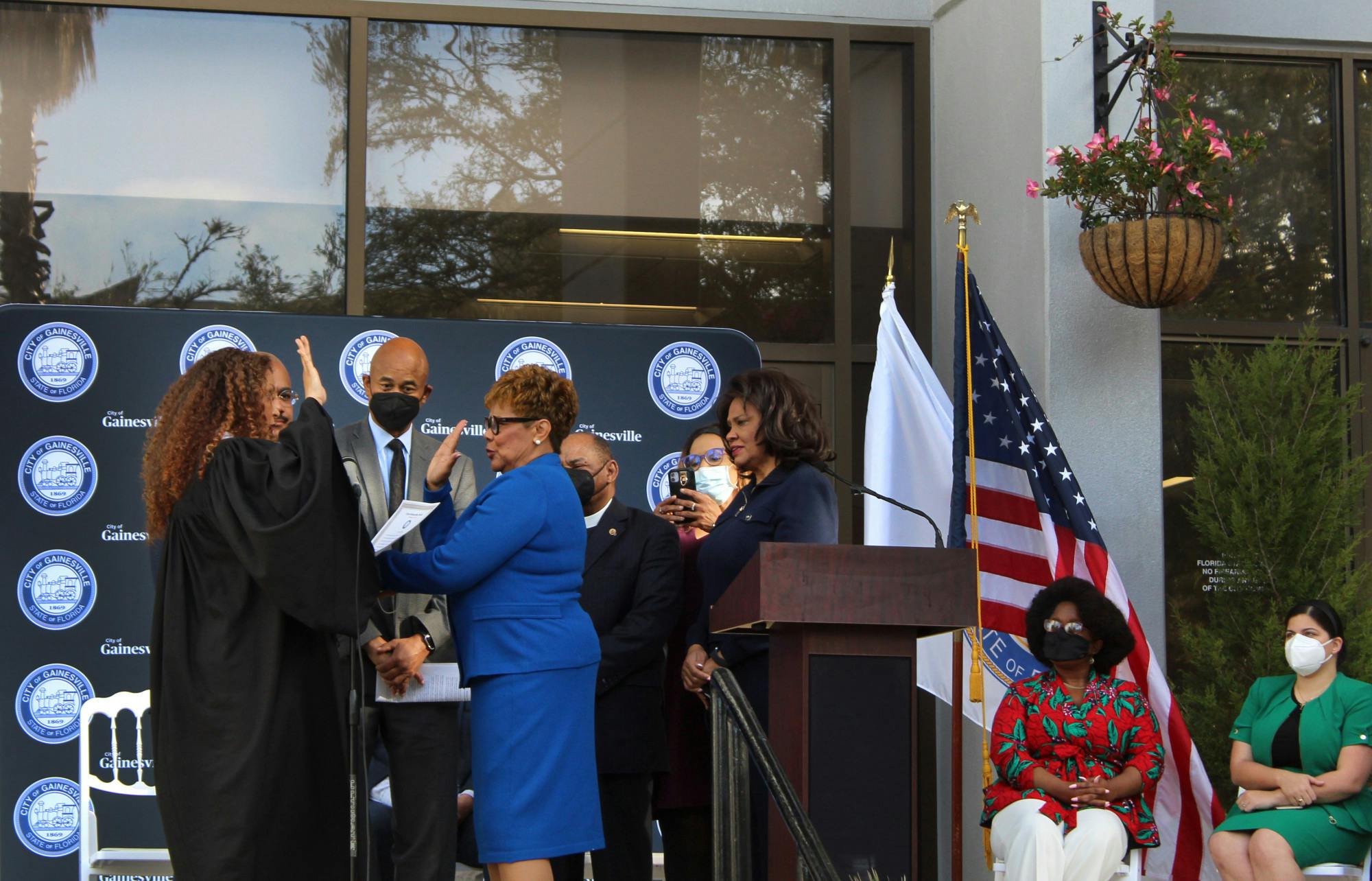 Cynthia Chestnut, dressed in blue, holds up her hand and takes an oath of office as the new At-Large Seat B city commissioner at Gainesville City Hall on Thursday, Feb. 17.