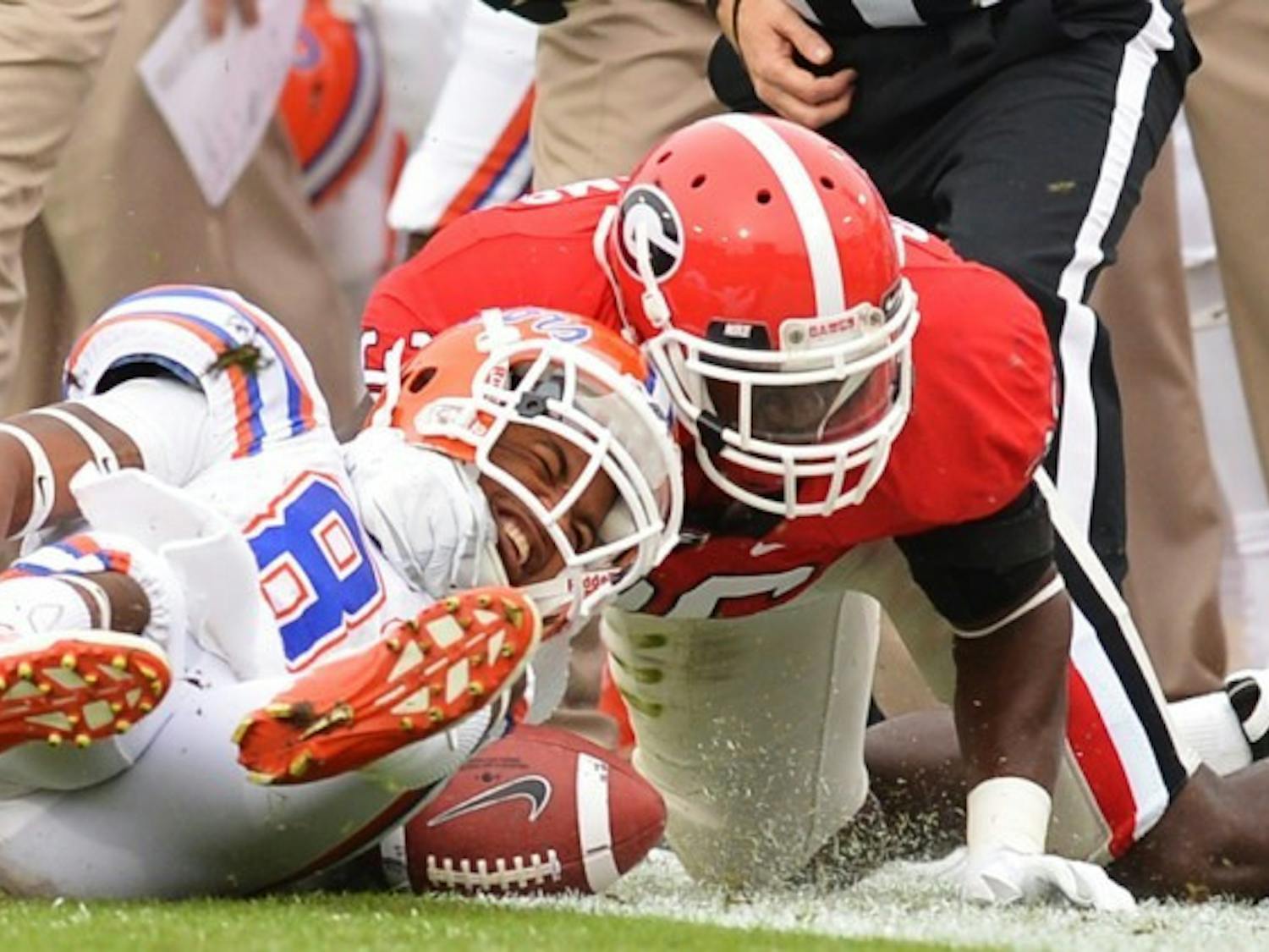 Junior Solomon Patton is tackled by Georgia safety Shawn Williams during UF's 17-9 loss on Saturday at EverBank Field. Patton suffered a broken left arm on the play.&nbsp;
