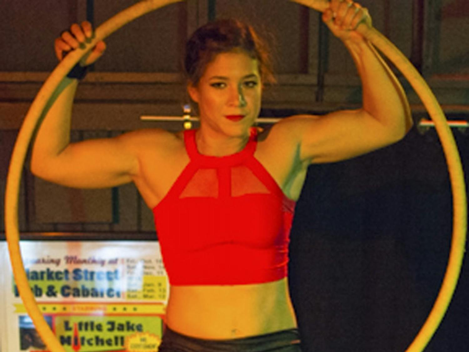 Kelly Ulmer, a 25-year-old AscenDance aerialist mental health counselor, swings from a lyra at Market Street Pub and Cabaret. Ulmer said she got bored with yoga and tried out an aerial arts class at S-Connection Aerial Arts, which started her love for the craft.