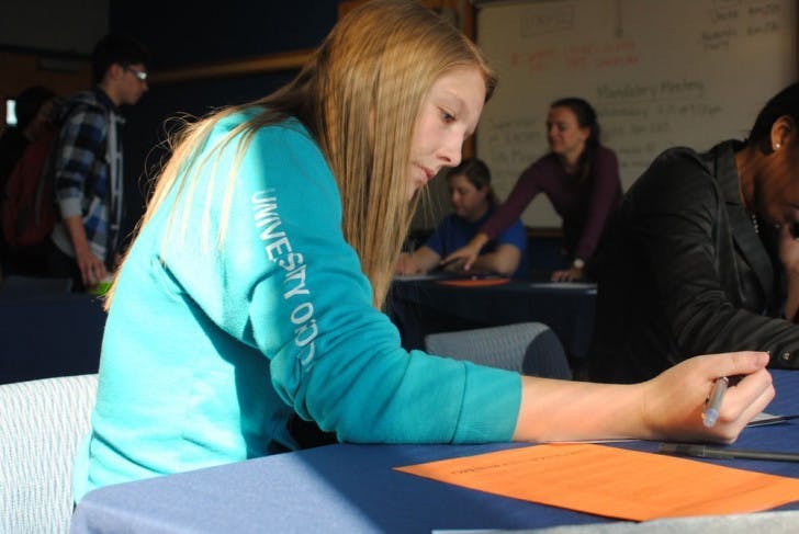 Pre-nursing&nbsp;sophomore Alexandra Desjardins-Martel fills out a Student Government slating form on Monday afternoon.