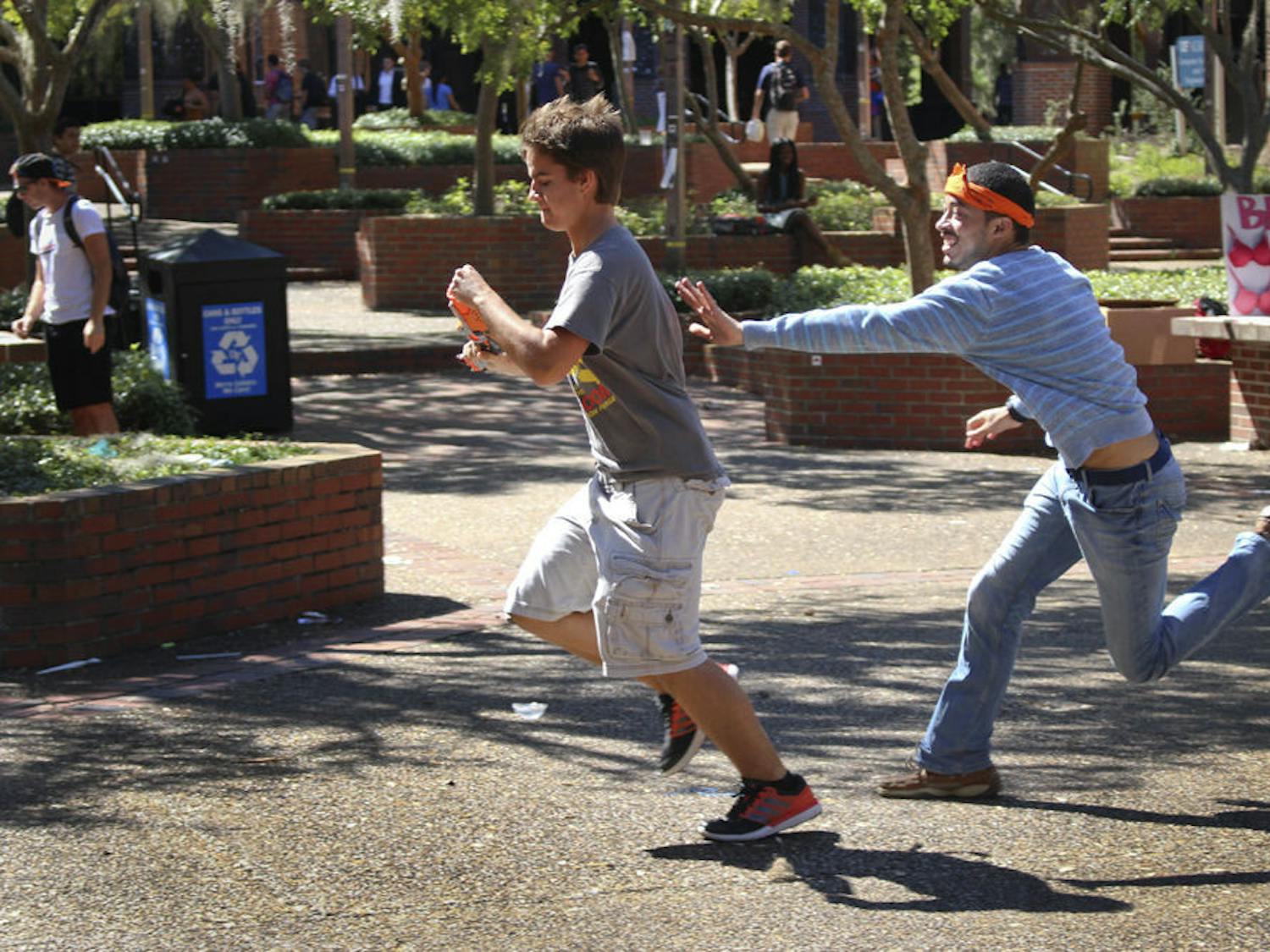 David Ayers chases Maddox Corcoran, a 20-year-old UF economics junior, on Turlington Plaza on Oct. 12, 2015. Gators Humans vs. Zombies began its four-day Summer game on Wednesday.
