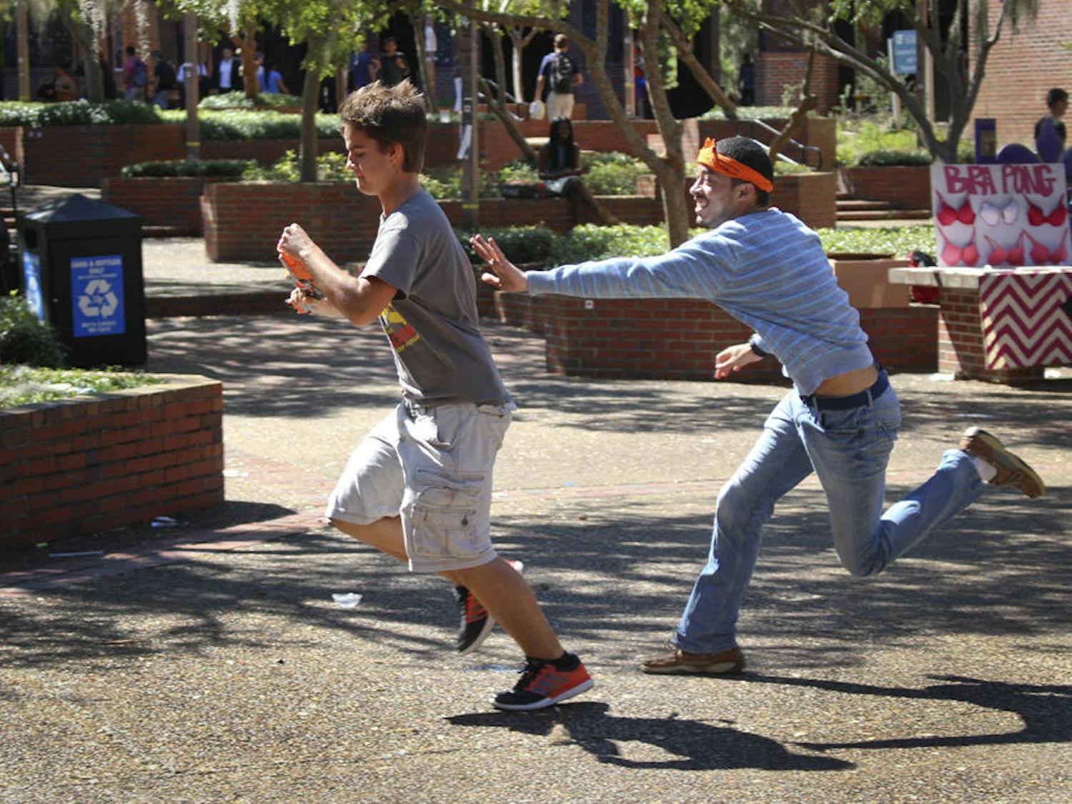 David Ayers chases Maddox Corcoran, a 20-year-old UF economics junior, on Turlington Plaza on Oct. 12, 2015. Gators Humans vs. Zombies began its four-day Summer game on Wednesday.
