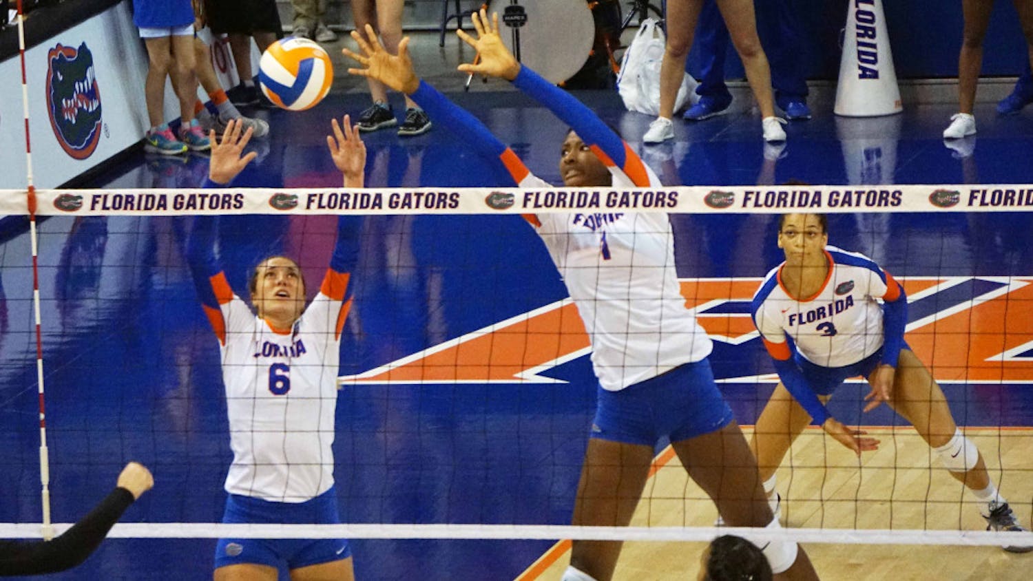 UF setter Mackenzie Dagostino (6) and middle blocker Rhamat Alhassan (1) jump for a block during Florida's 3-1 win on Sept. 20, 2015, in the O'Connell Center.