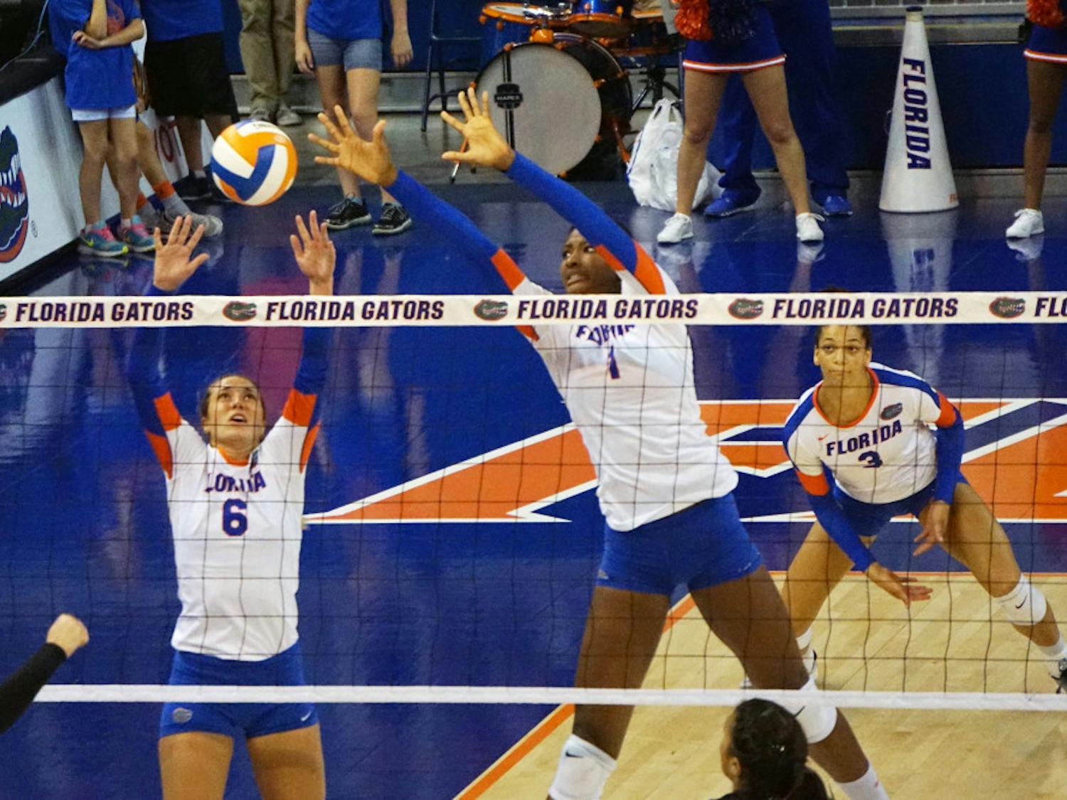 UF setter Mackenzie Dagostino (6) and middle blocker Rhamat Alhassan (1) jump for a block during Florida's 3-1 win on Sept. 20, 2015, in the O'Connell Center.