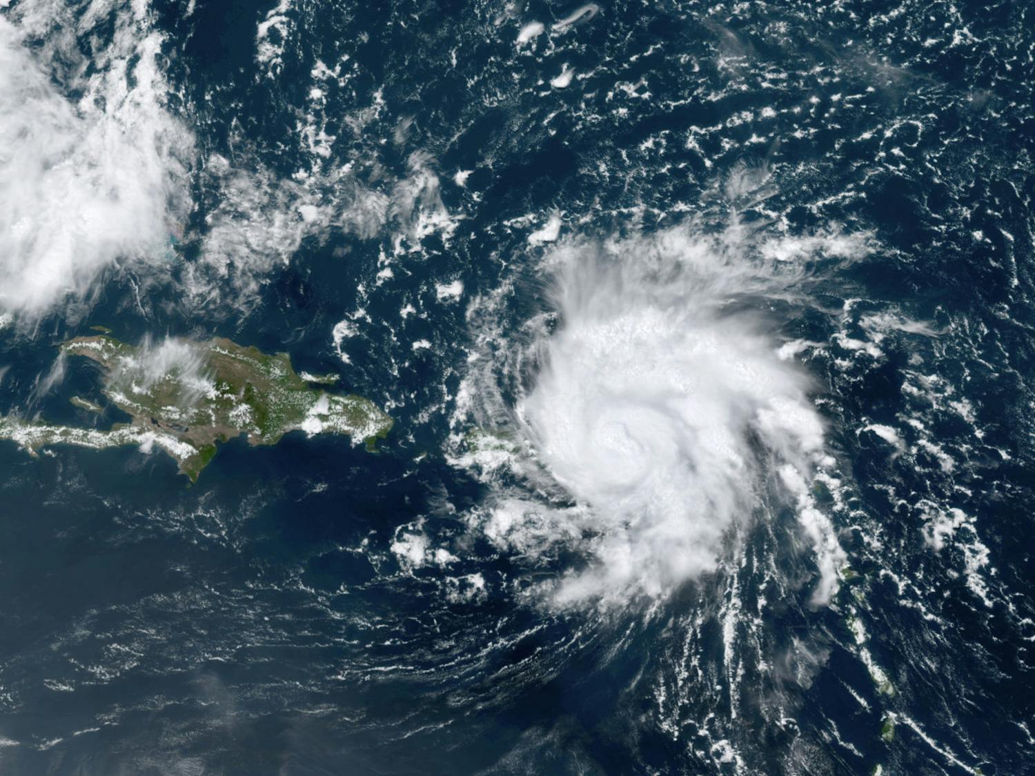 This GOES-16 satellite image taken Wednesday, Aug. 28, 209, at 17:20 UTC and provided by National Oceanic and Atmospheric Administration (NOAA), shows Dorian, a Category 1 hurricane, crossing over the U.S. and British Virgin Islands. Forecasters say it could grow to Category 3 status as it nears the U.S. mainland as early as the weekend. (NOAA via AP)