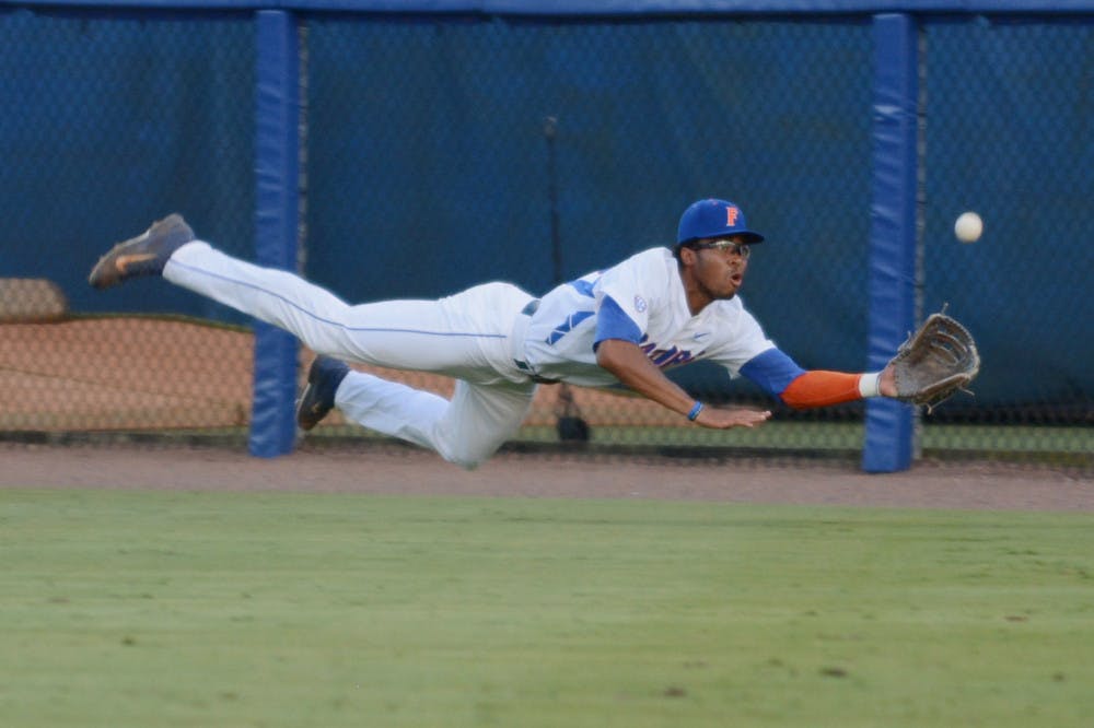 Buddy Reed makes a diving grab in the outfield during Florida's 19-0 win over Florida A&amp;M on May 29, 2015, during the 2015 NCAA Tournament.