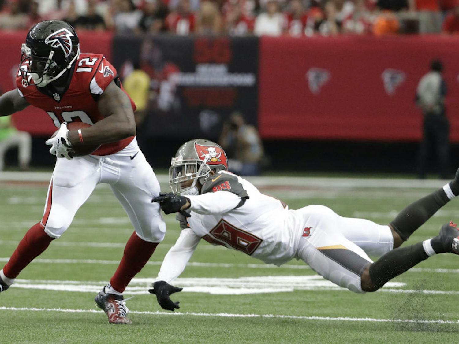 Atlanta Falcons wide receiver Mohamed Sanu (12) moves past Tampa Bay Buccaneers cornerback Vernon Hargreaves (28) during the second half of an NFL football game, Sunday, Sept. 11, 2016, in Atlanta. (AP Photo/David Goldman)