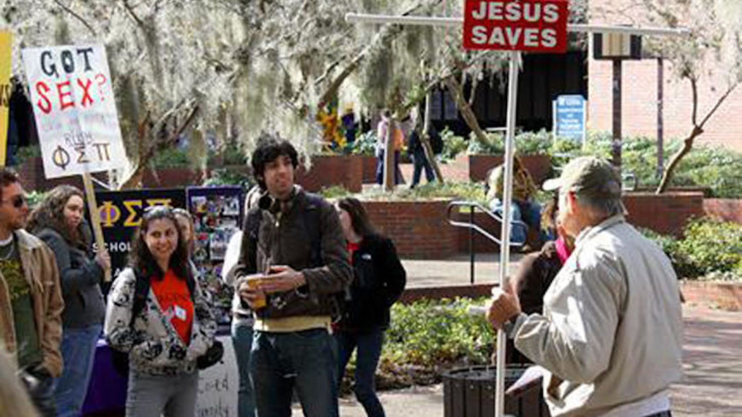 Junior Lofton, a Christian preacher, talks to a group of pro-Israeli protesters and students. Lofton, 73, has been preaching to students for 32 years as of April 2014 and typically visits Turlington Plaza three days a week.