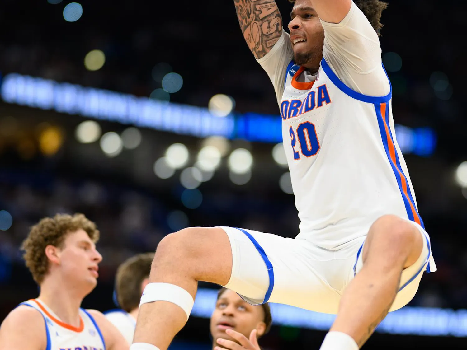 Florida guard Isaiah Brown (20) hangs on the rim after a dunk during the first half of an NCAA Tournament first round game against Prairie View A&M, Friday, March 20, 2026, in Tampa, Fla.
